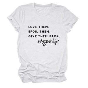 Detailed view of white cotton t-shirt with Love Them Spoil Them black slogan print