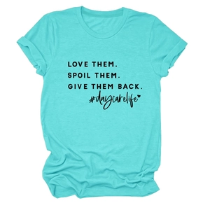 Detail of teal crew neck t-shirt showing the Love Them Spoil Them text and cotton texture