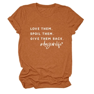 Detail of Love Them Spoil Them text on brick red heather fabric crew neck t-shirt