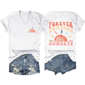 Flat lay of white V-neck T-shirt with Forever Chasing Sunsets print and denim shorts