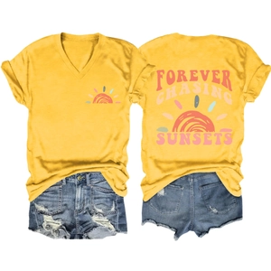 Detail view of yellow V-neck T-shirt with Forever Chasing Sunsets print and denim shorts