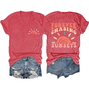 Flat lay of red V-neck T-shirt with sun graphic and denim shorts with ripped details
