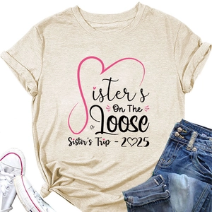 Flat lay of oatmeal T-shirt with 'Sisters On The Loose' print and denim jeans