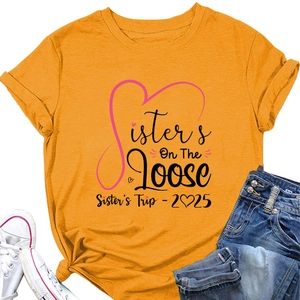 Detail of mustard yellow t-shirt with Sisters On The Loose print and rolled sleeve cuffs