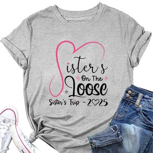 Detail of Sisters On The Loose grey T-shirt with 2025 Sister's Trip graphic and pink hearts