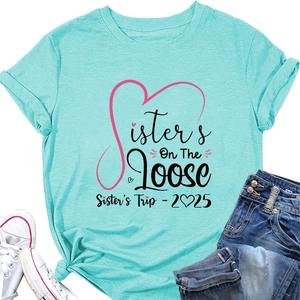 Detail of mint green Sisters On The Loose t-shirt with heart graphic and artistic text