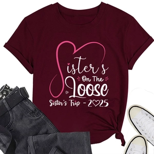 Close-up of Sisters On The Loose print and rolled sleeve on maroon cotton t-shirt