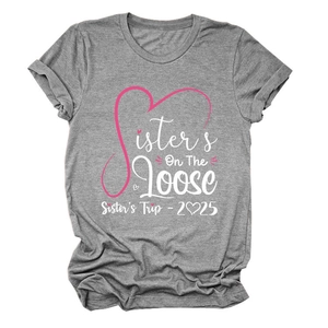Close-up of Sisters On The Loose pink graphic print on grey cotton t-shirt fabric