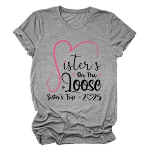 Detail of Sisters On The Loose print on heather grey cotton t-shirt with sister trip 2025 text