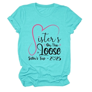 Detail of teal cotton T-shirt featuring Sister's Trip 2025 graphic with heart accents