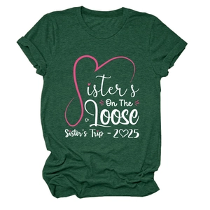 Detail of Sisters On The Loose 2025 trip text and heart print on heather green t-shirt