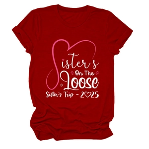 Detail of red crew neck T-shirt with white and pink Sisters On The Loose 2025 print