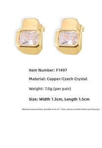Detail of geometric gold earrings with large rectangular cubic zirconia in a bezel setting