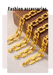 Macro view of gold-plated square link chain bracelet with lobster clasp on wood