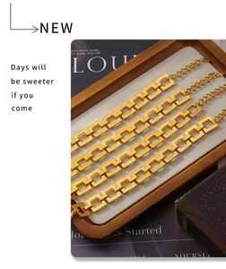 Close-up of gold stainless steel rectangular link bracelets with adjustable chains