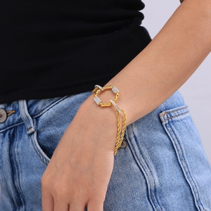 Detailed view of gold twisted chain bracelet with crystal pavé circular link accents