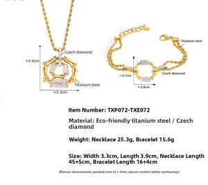 Detail of gold titanium steel jewelry set with twisted chain and crystal column charms
