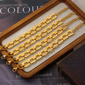 Set of four 18k gold plated stainless steel checkered link bracelets on a wooden tray