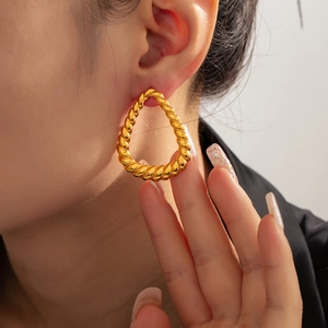 Elegant gold twisted teardrop hoop earrings for women in a luxury aesthetic