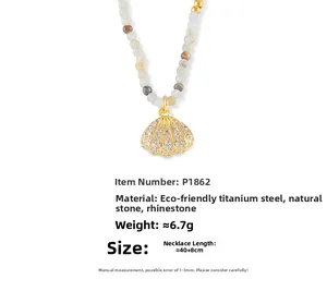 Detail of seashell pendant necklace with 18k gold-plated titanium steel and natural stones