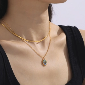 Double layered gold necklace set with flat snake chain and oval star shell pendant