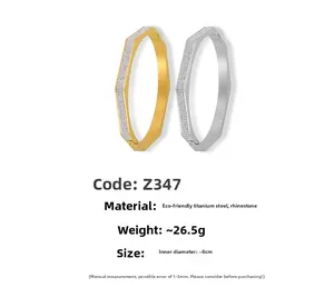 Detailed view of gold and silver hexagon titanium steel bangles with sparkling crystals