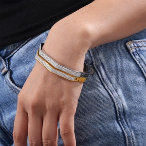 Three-tone geometric zircon bangles in gold, silver and black finish on wrist