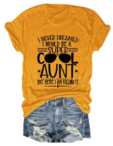 Close-up of yellow graphic T-shirt with 'Super Cool Aunt' slogan and denim shorts set