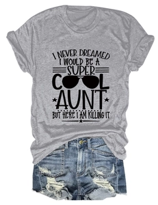 Flat lay detail of grey round neck T-shirt with graphic quote and denim shorts