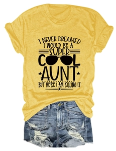 Flat lay of women's yellow graphic T-shirt and distressed denim shorts with frayed hems