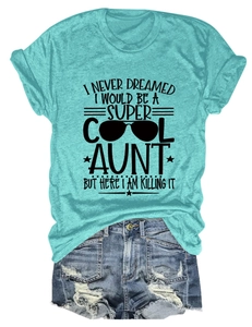 Flat lay of lake blue t-shirt with Super Cool Aunt text and distressed denim shorts