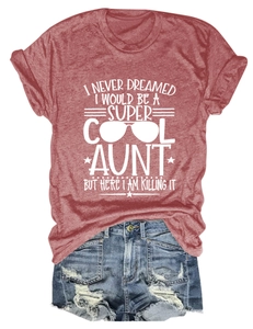 Detail of red Cool Aunt print T-shirt paired with distressed denim shorts on white background