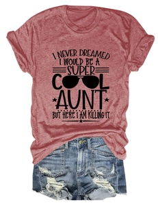 Flat lay of a heather red slogan t-shirt with ripped denim shorts and sunglasses graphic