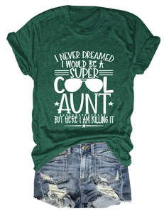 Flat lay of a dark green crew neck T-shirt with white AUNT slogan and denim shorts