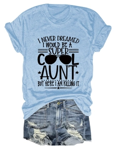 Flat lay of a blue T-shirt with Super Cool Aunt print and ripped denim shorts outfit