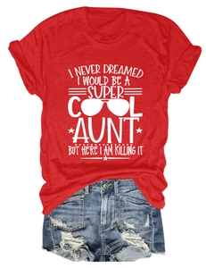 Flat lay of red cotton t-shirt and distressed denim shorts with artistic white print