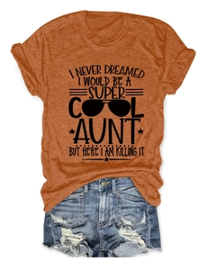 Orange aunt slogan T-shirt paired with distressed blue denim shorts in a flat lay view