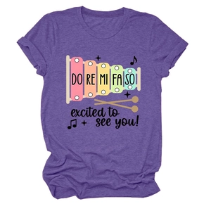 Détail d'un t-shirt violet à manches courtes avec imprimé xylophone et texte imprimé