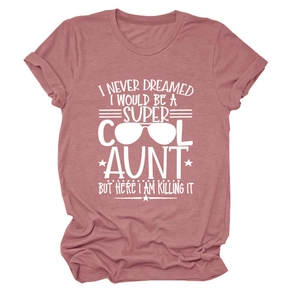 Close-up of pink crewneck T-shirt with white Super Cool Aunt printed text and sunglasses