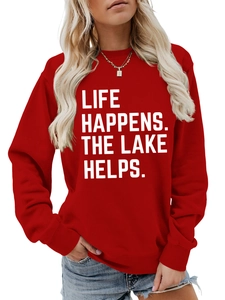 Detail of red crewneck sweatshirt featuring white Life Happens Lake Helps slogan