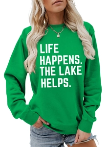 Detail of green crewneck sweatshirt featuring white Life Happens Lake Helps slogan