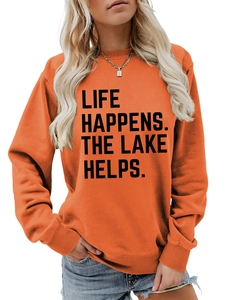 Detail of ribbed cuffs and Life Happens The Lake Helps print on orange sweatshirt