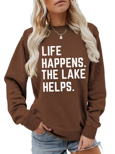 Detailed view of white Life Happens letter print on brown long sleeve crewneck sweatshirt