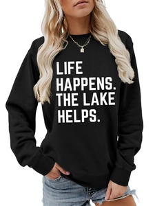 Detail of white Life Happens The Lake Helps text print on a black long sleeve sweatshirt