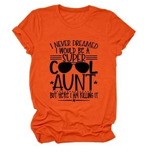 Detail of bright orange cotton T-shirt featuring black artistic text and sunglasses graphic