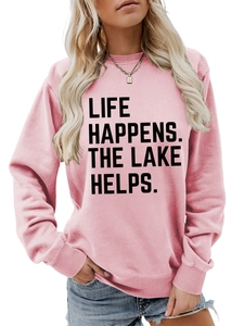 Close-up of pink crewneck sweatshirt with black Life Happens The Lake Helps slogan print