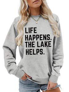 Detail of grey crewneck sweatshirt featuring Life Happens The Lake Helps slogan print