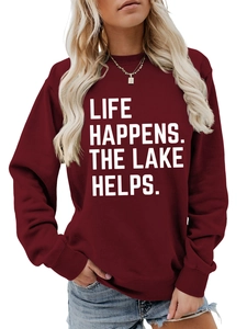 Detail of white slogan print on wine red long-sleeved sweatshirt for women