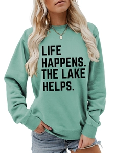 Close-up of LIFE HAPPENS THE LAKE HELPS text on mint green long sleeve sweatshirt