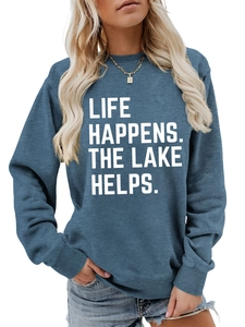 Detail of blue crewneck sweatshirt with Life Happens The Lake Helps white letter print